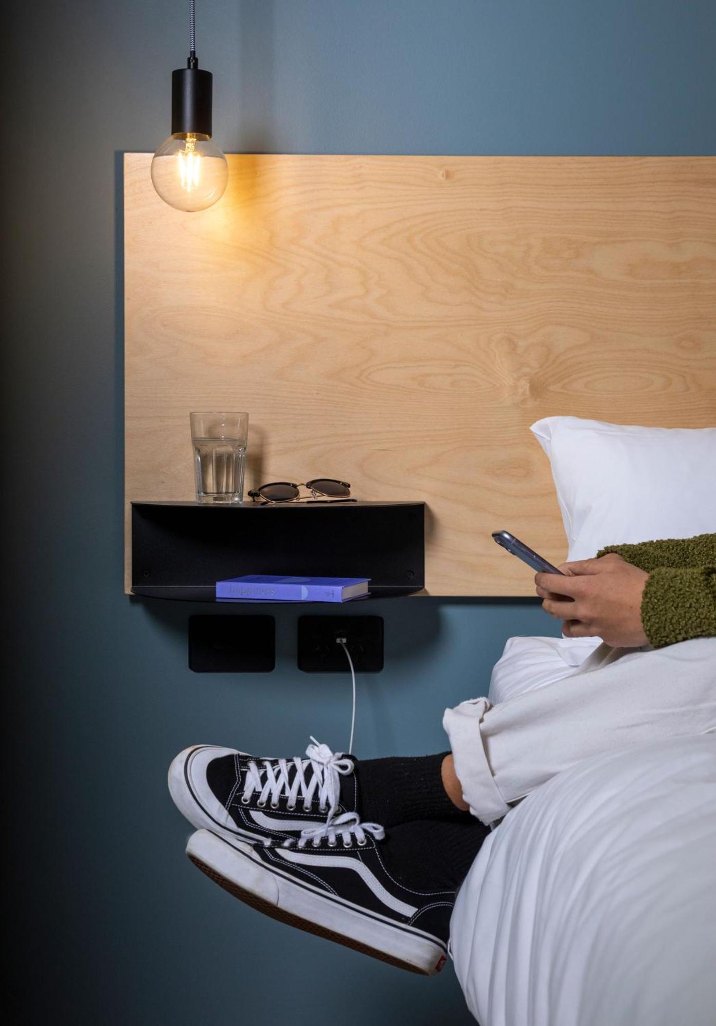 Lylo Auckland Hotel Room photo A phone being used in bed